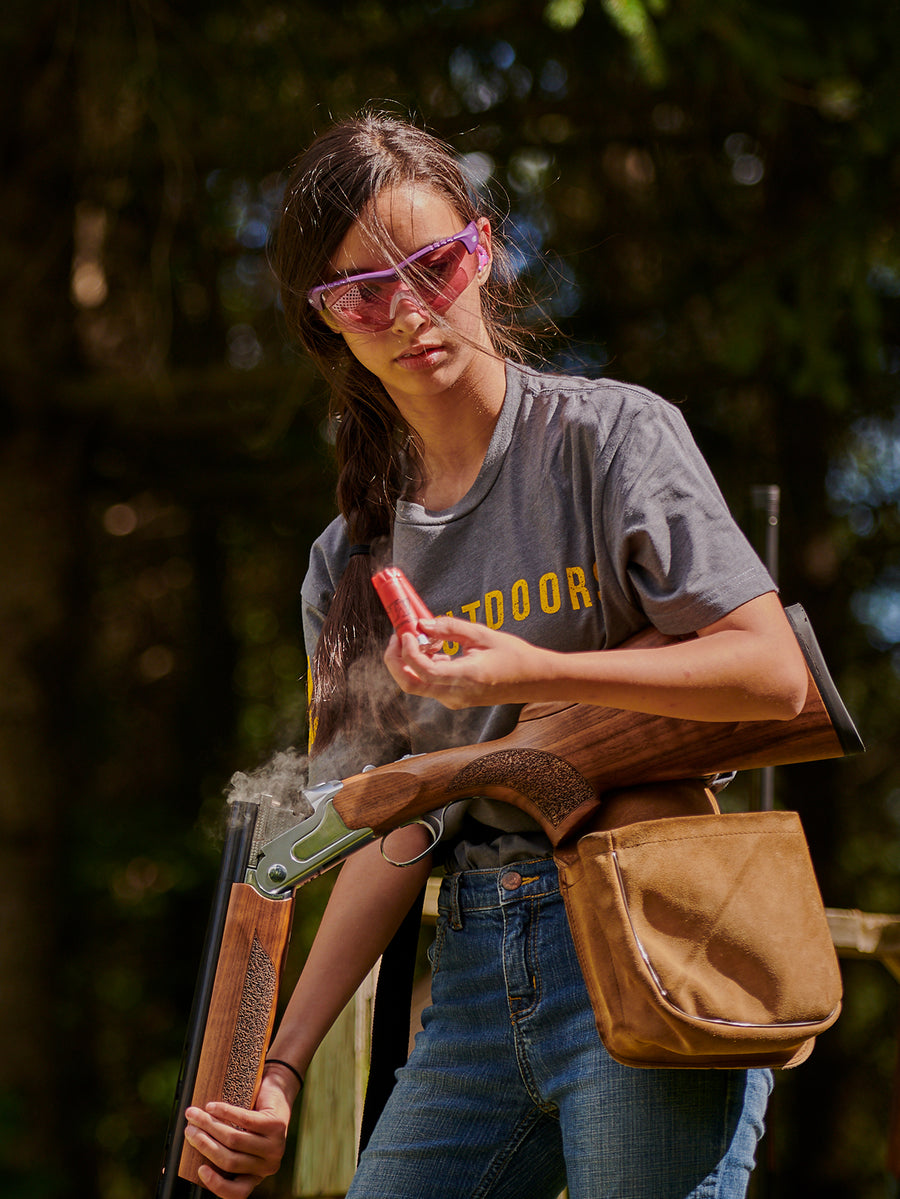 Young clay shooter wearing Methow glasses at the range.