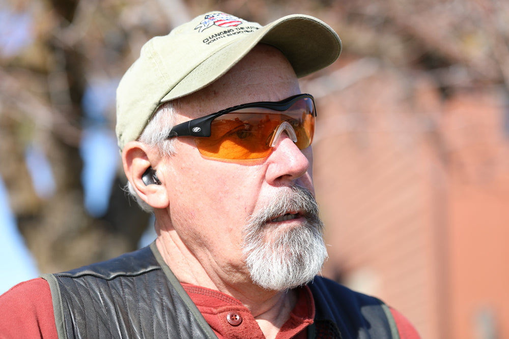 Man outdoors wearing a black Methow frame with a Dark Orange lens