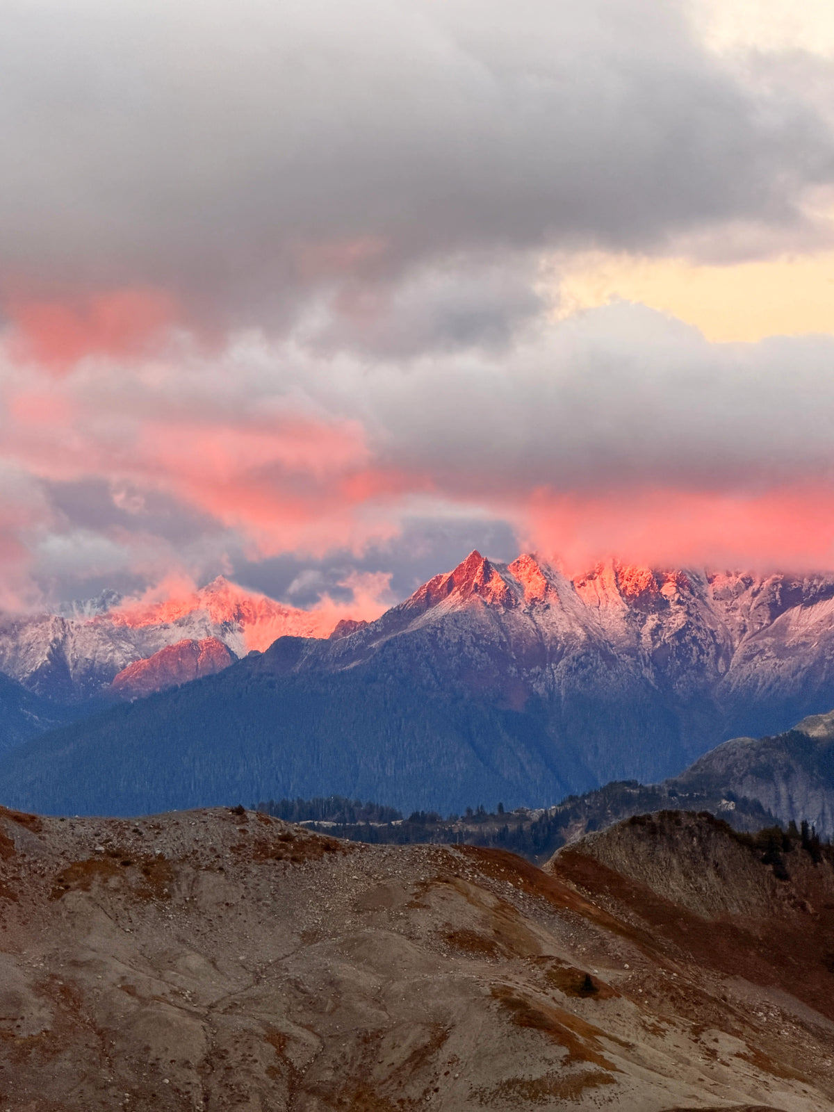 Pink sunset clouds above snow-covered Cascade mountain peaks, photographed on the Methow trip.