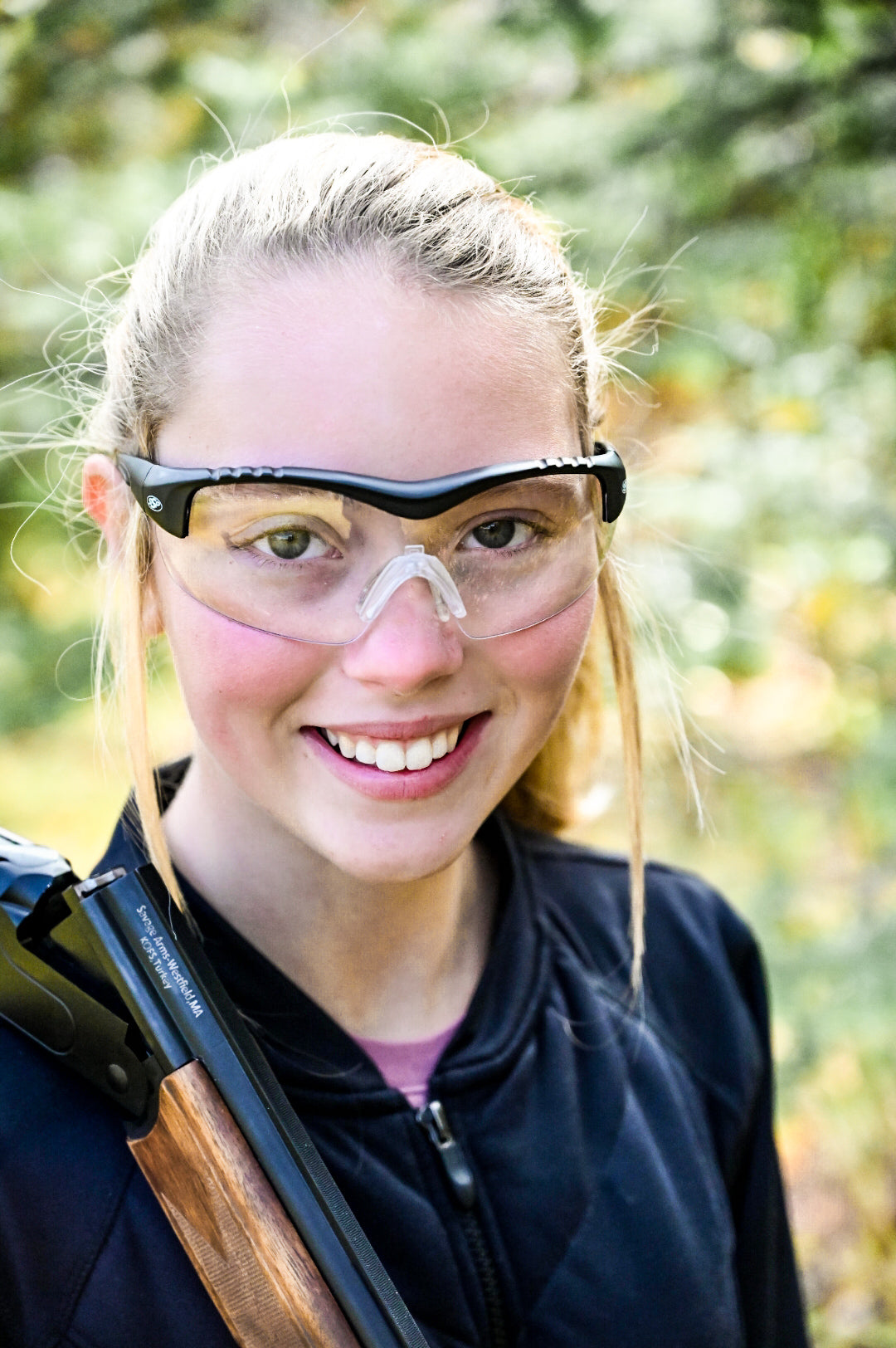 Young wearer smiling in clear Methow eyewear outdoors