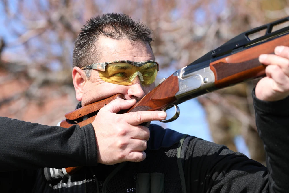 Shooter wearing Methow glasses with the shotgun pointed away from the camera