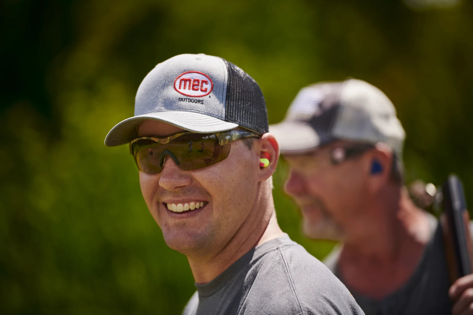 Smiling man wearing Methow glasses with Kiwi lenses outdoors